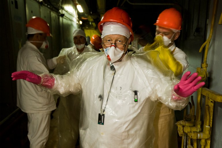 Gerd Ludwig dressed in protective clothing to accompany a group of workers