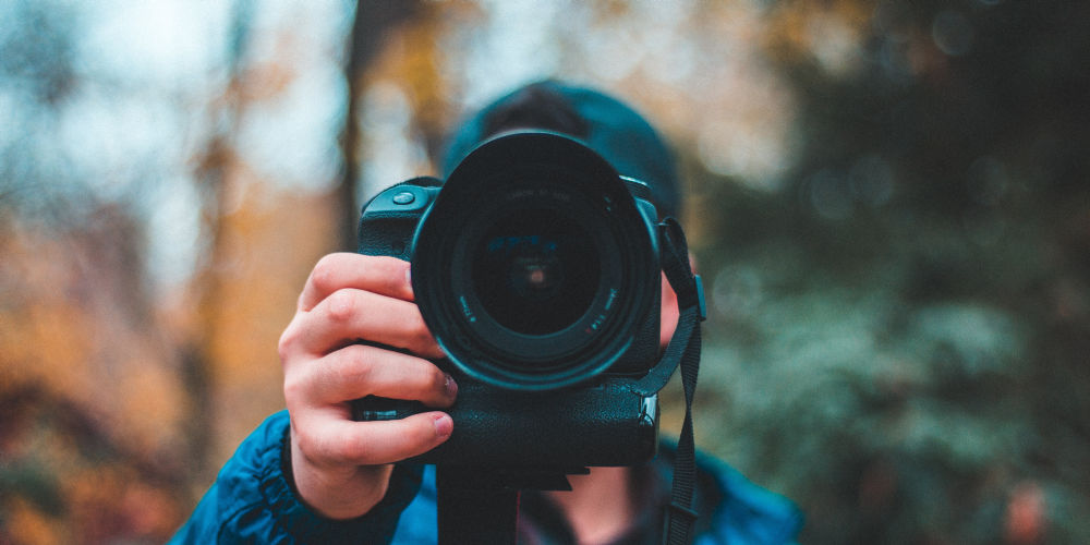 Photographer holding black camera