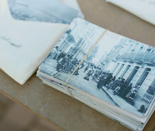 Historical postcards piled on a table